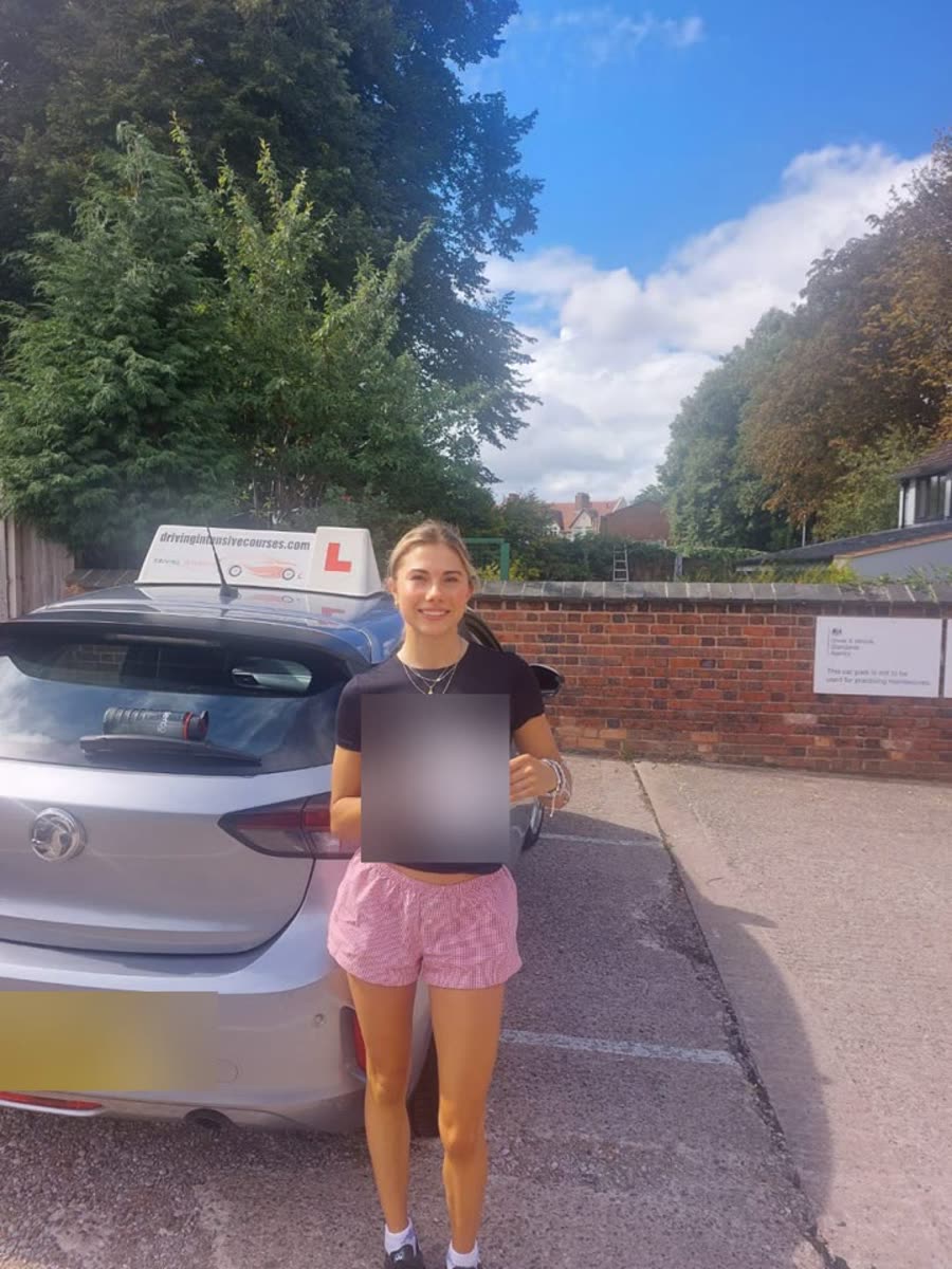 Learner celebrating beside a Driving Intensive Courses car